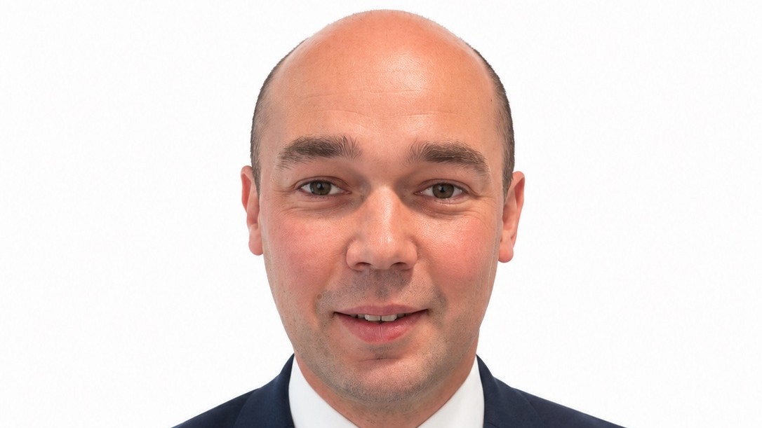 Head-and-shoulders portrait of Bidwells associate Luke Davenport in a navy suit and patterned tie