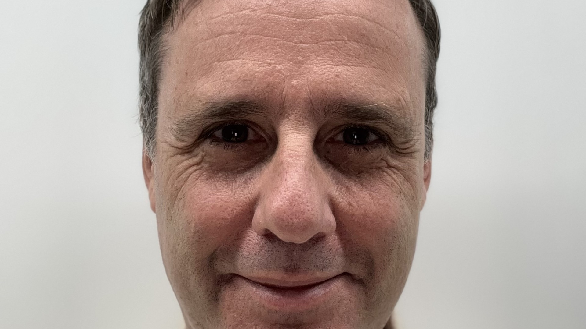 Head-and-shoulders portrait of Carter Jonas planning partner Peter Disley wearing a light shirt