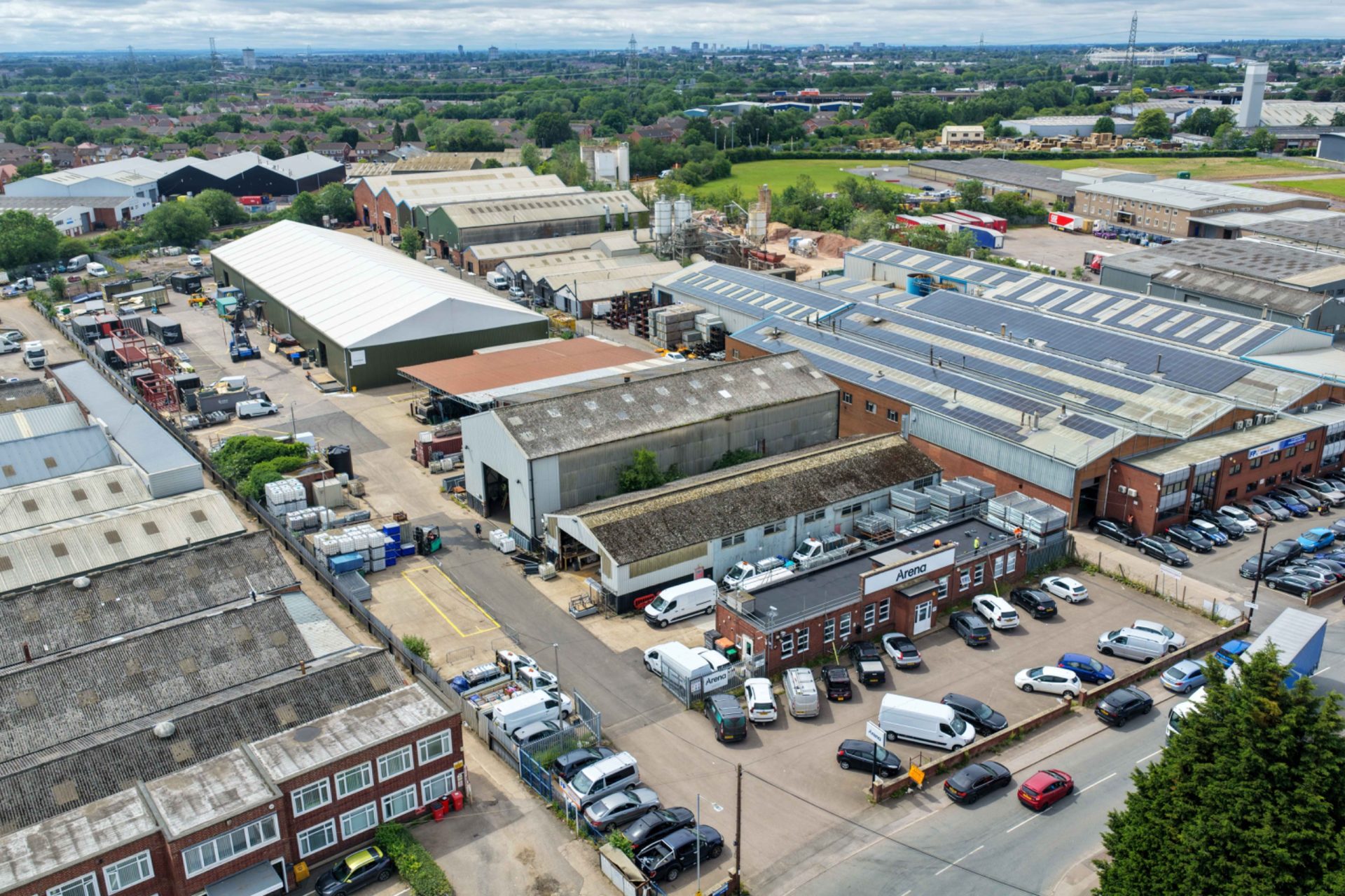Aerial view of warehouses and industrial units at 40 Bayton Road, Coventry, with parked cars and loading areas.