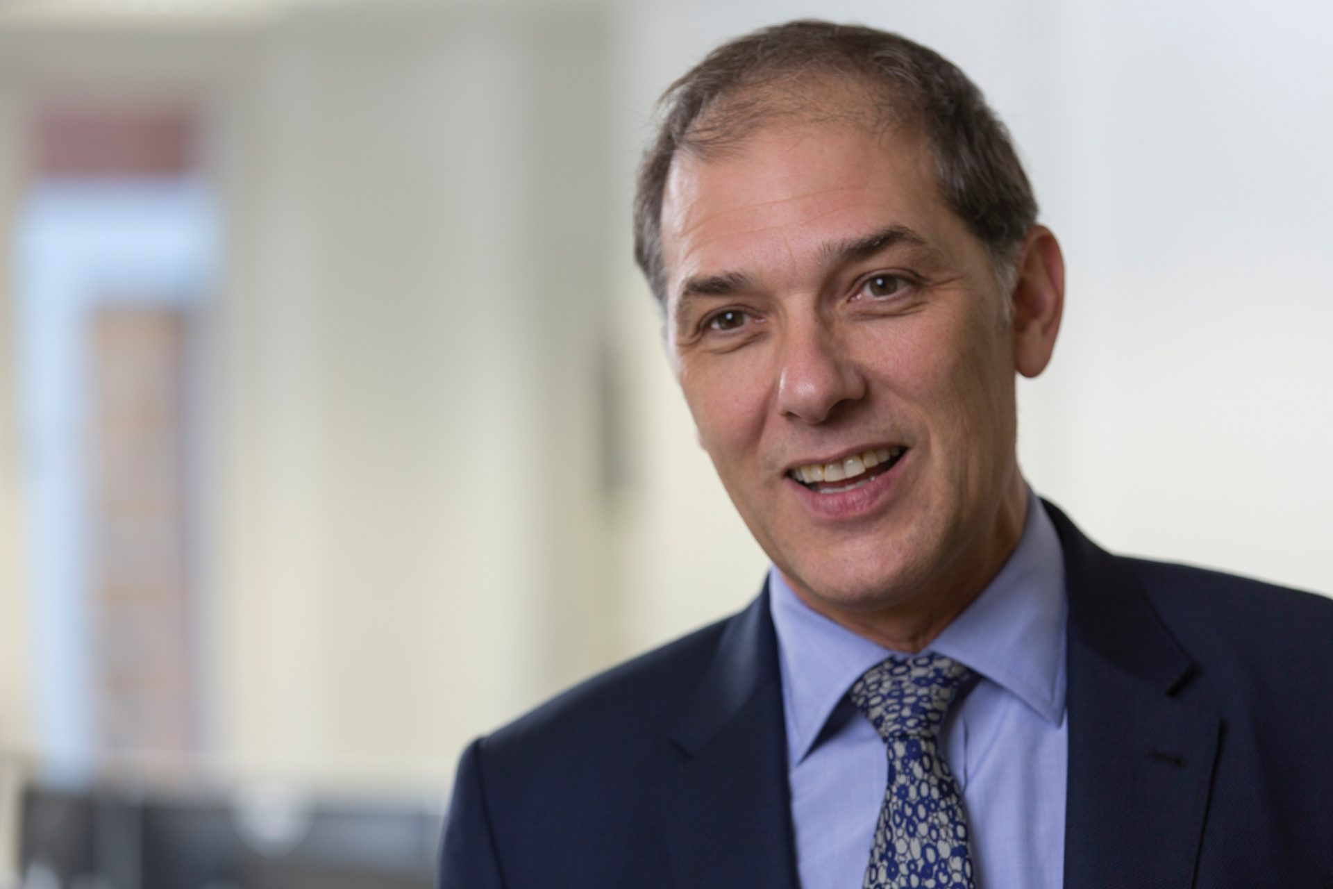 Property professional in a suit smiling for a portrait