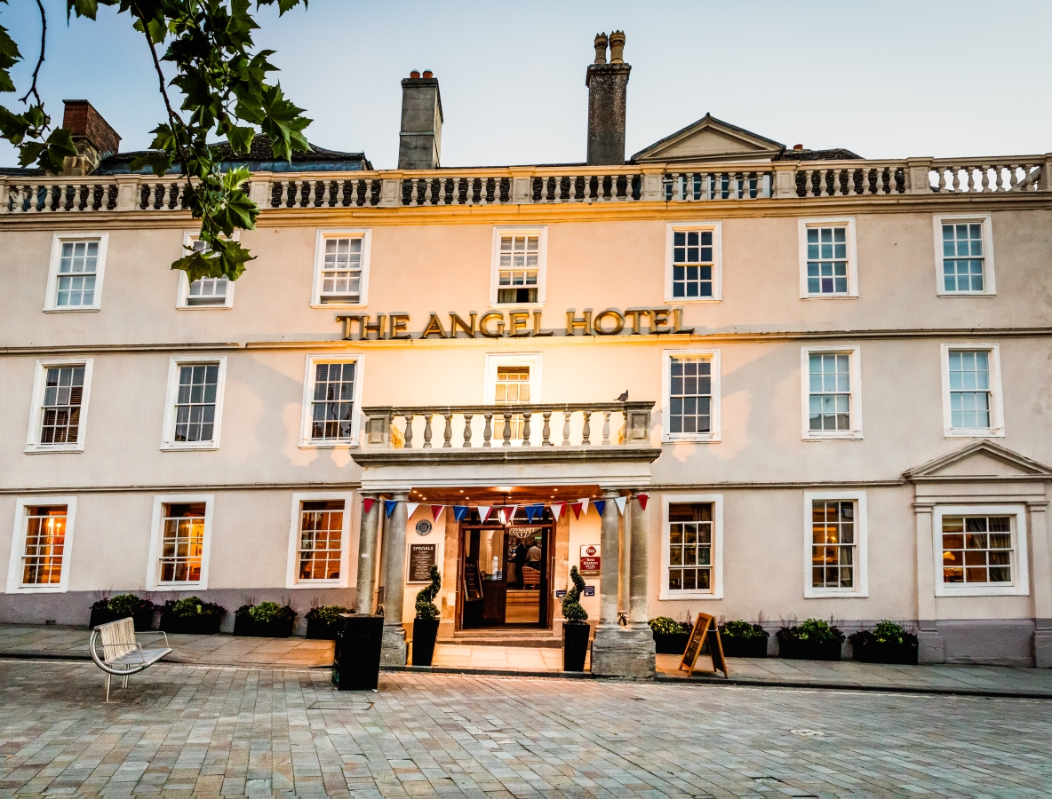 The Angel Hotel historic facade and main entrance viewed from a paved courtyard