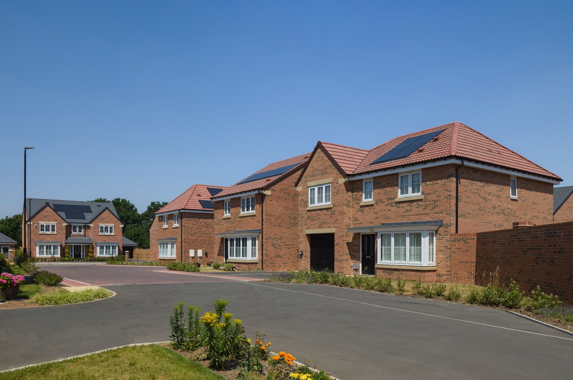 New-build Miller Homes properties lining a landscaped residential street in the UK