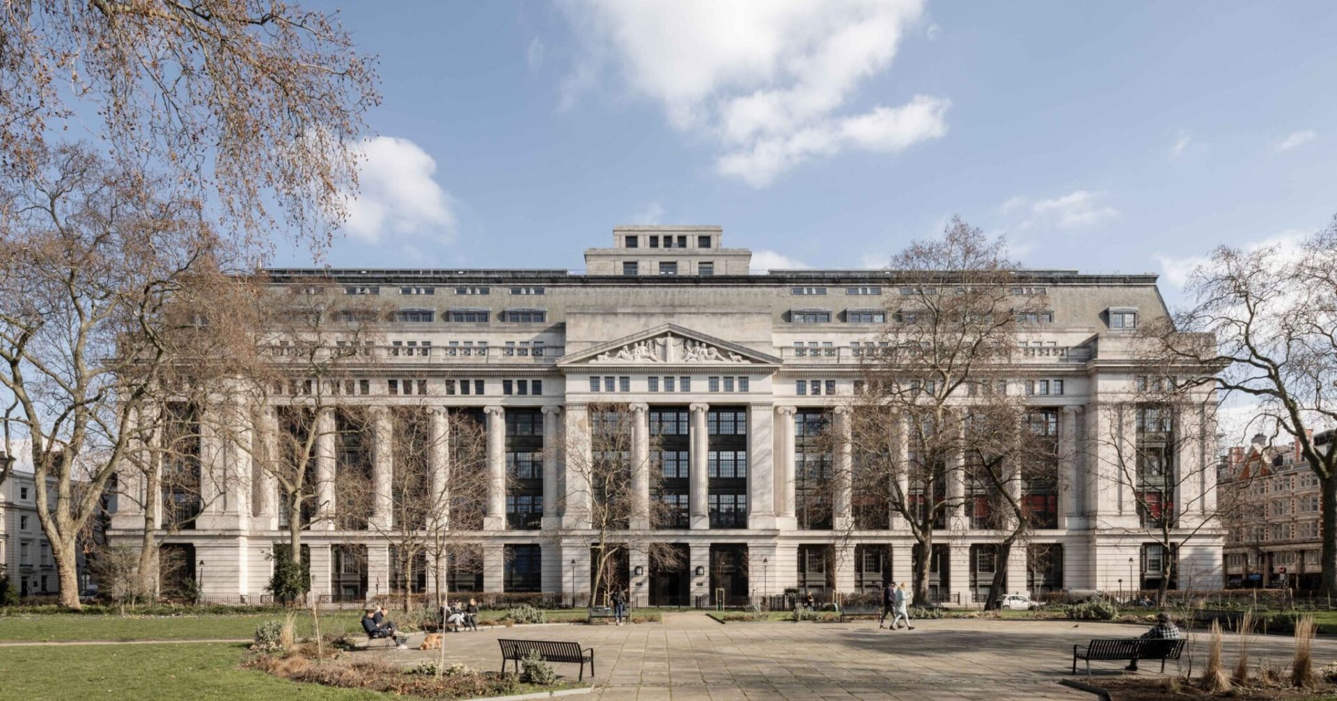 Victoria House in Bloomsbury, London, a grand neoclassical building viewed from its tree-lined plaza.