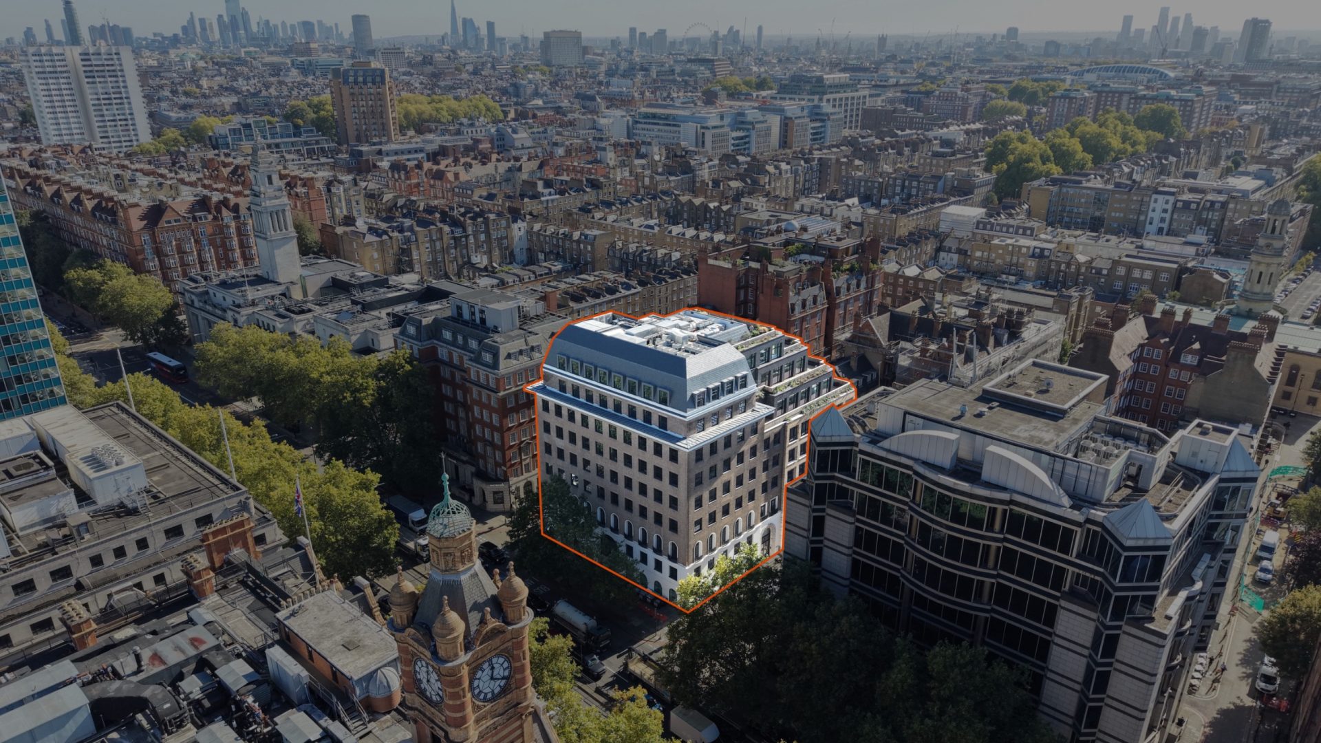 Aerial view of a highlighted commercial building within a dense UK city centre