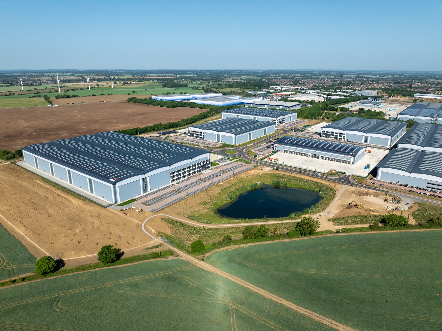 CGI aerial view of a series of industrial units surrounded by fields