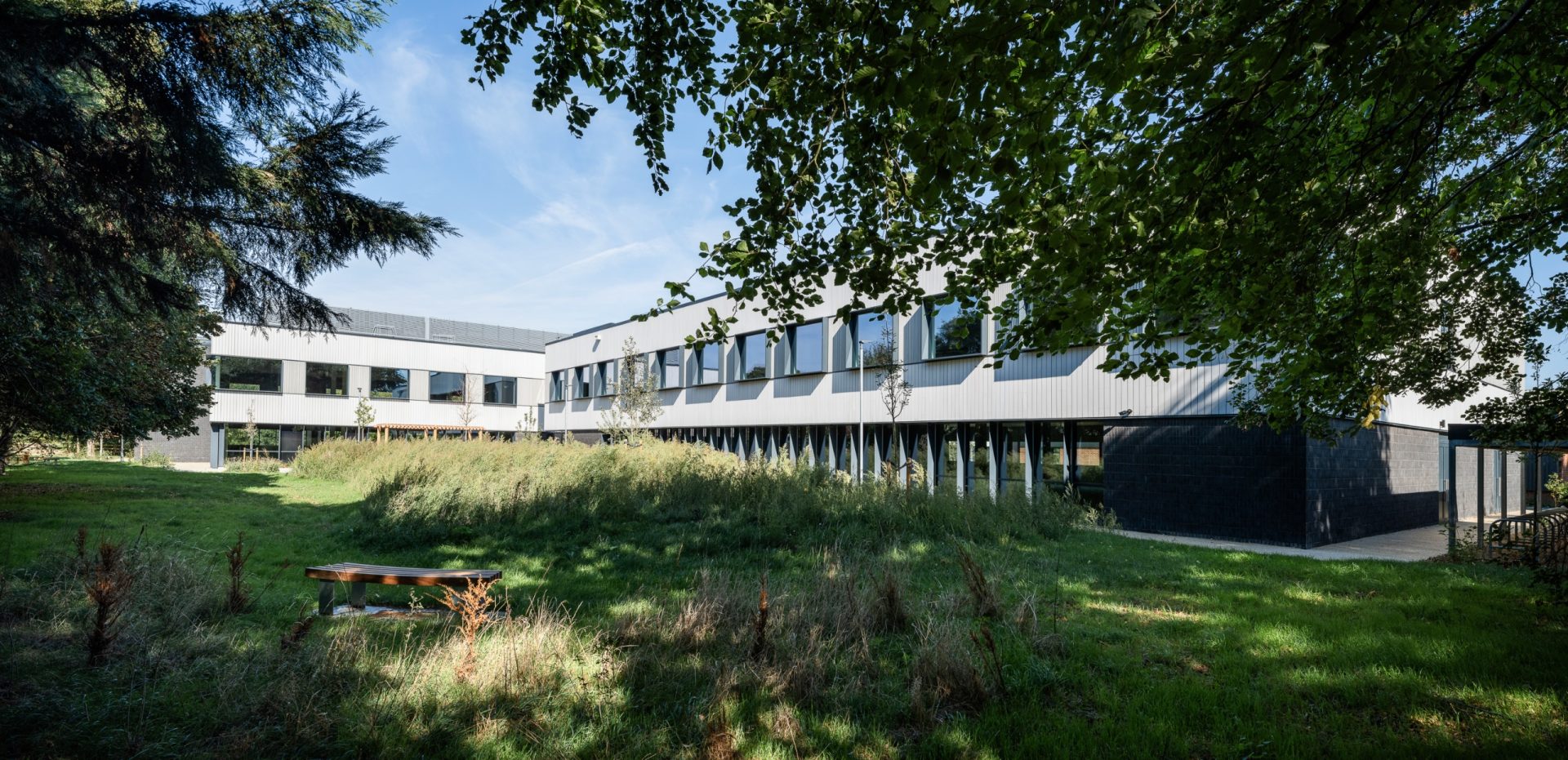 The Press science campus in Foxton, a modern low-rise building behind a lawn and trees.