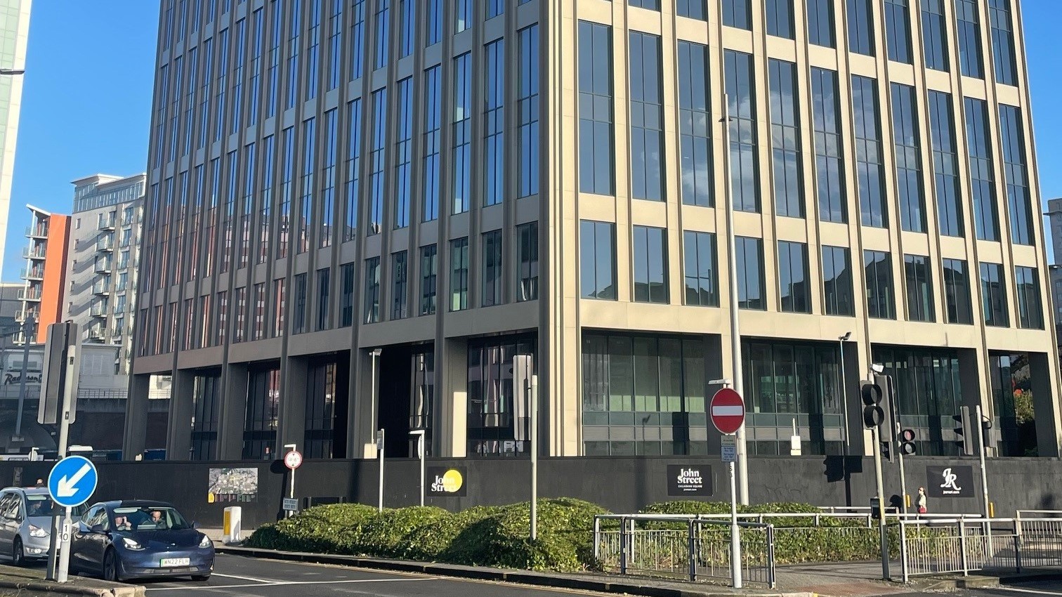 No 1 John Street, a modern 10-storey office building in Cardiff, viewed from across the street.