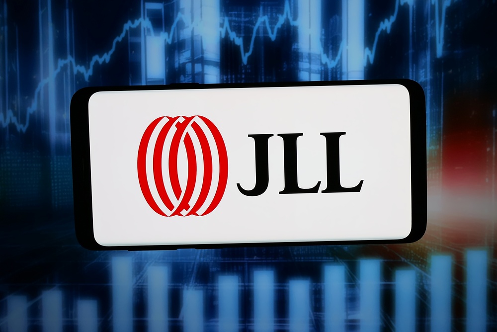 JLL logo displayed on a smartphone against an abstract digital background