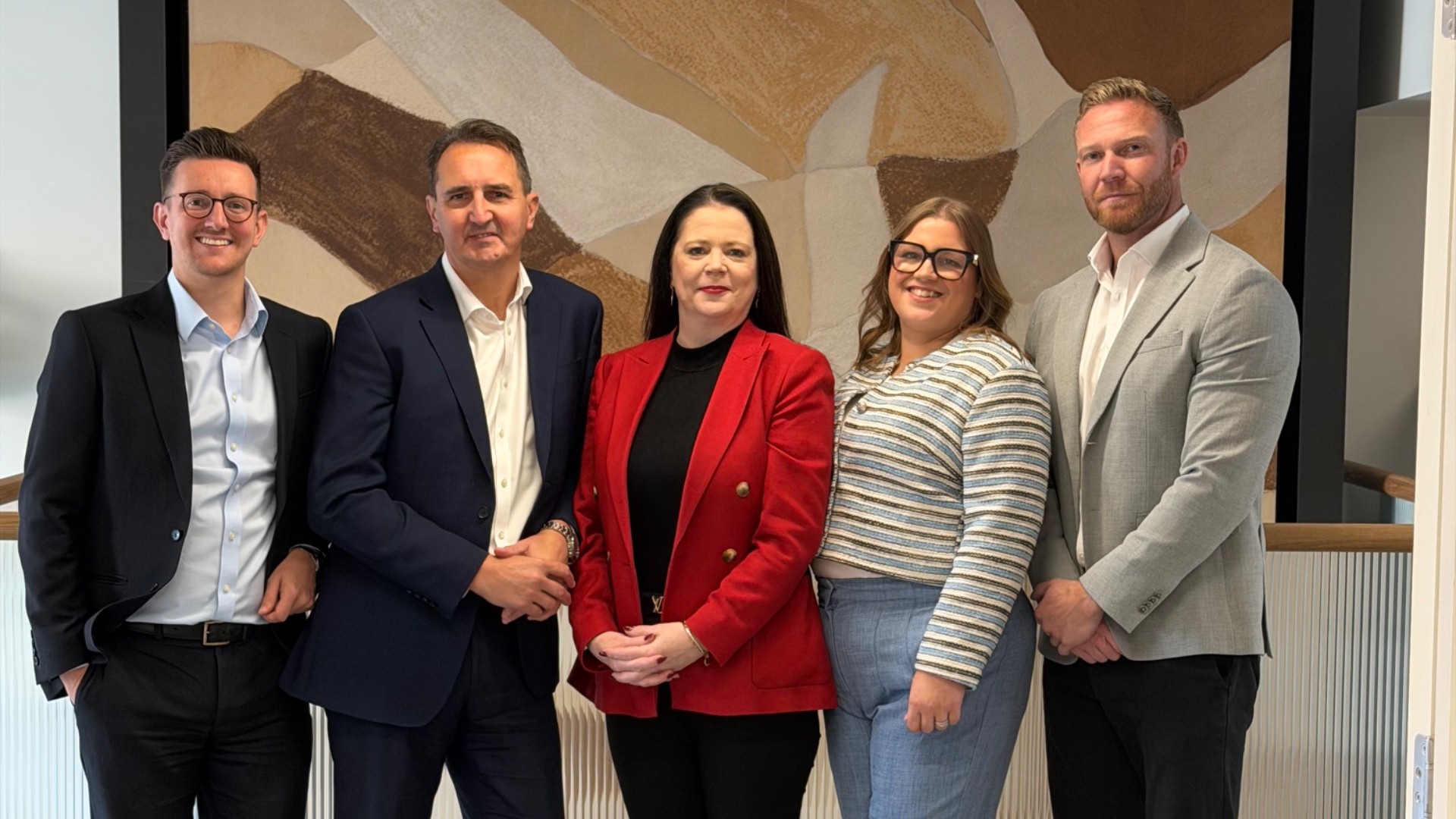 Five Allsop Letting and Management board members stand together in a meeting room.
