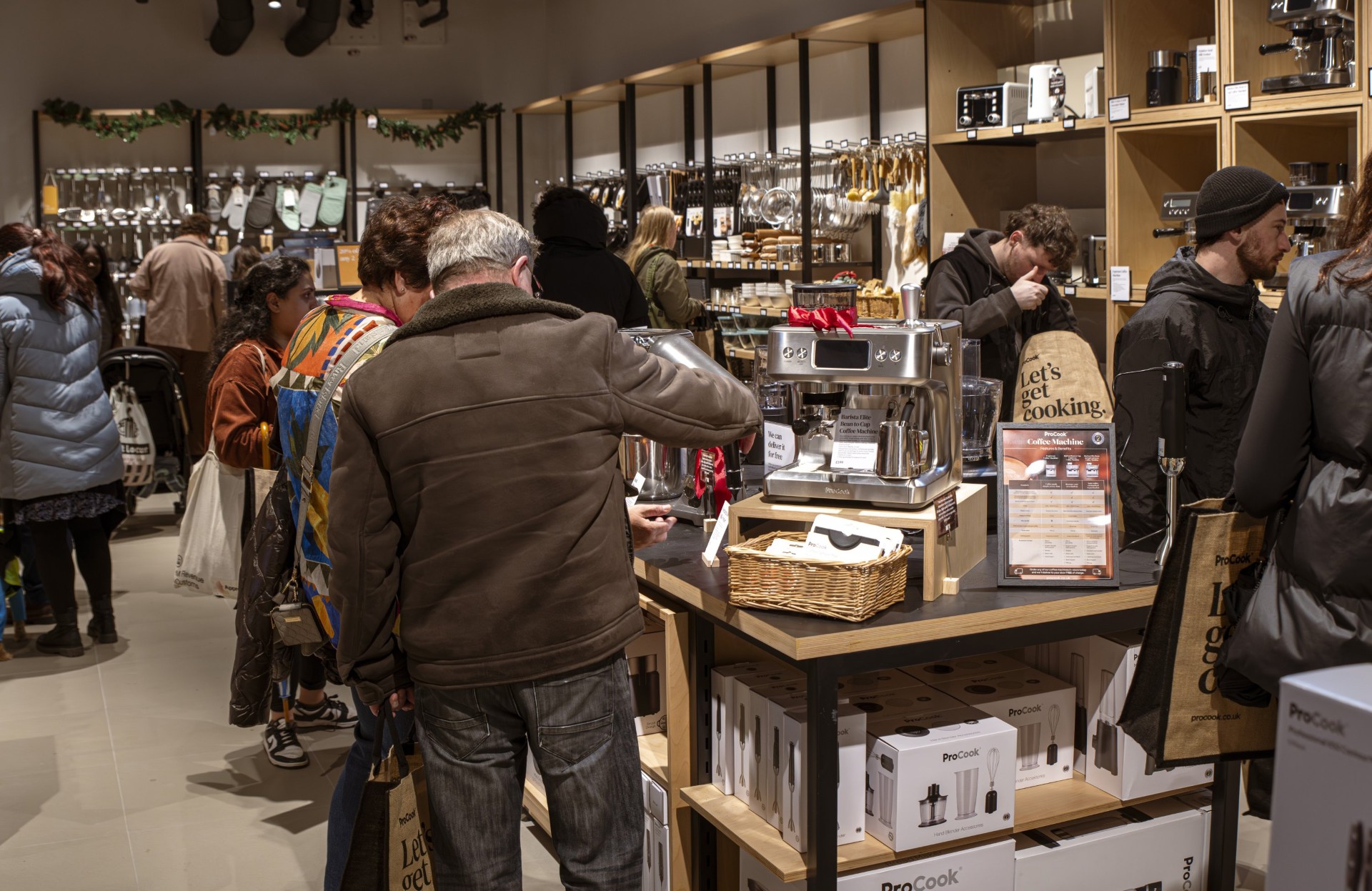 Shoppers browse cookware and kitchen accessories in a ProCook store.