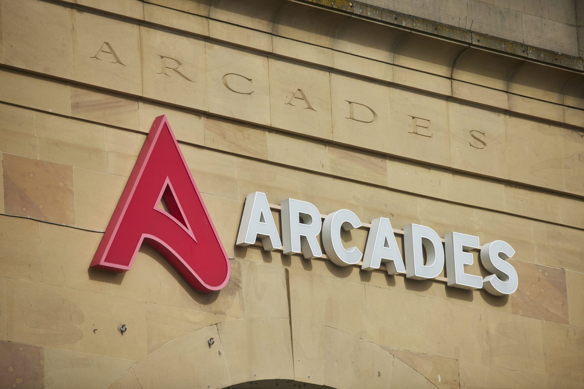 Large ARCADES sign mounted on the facade of a building