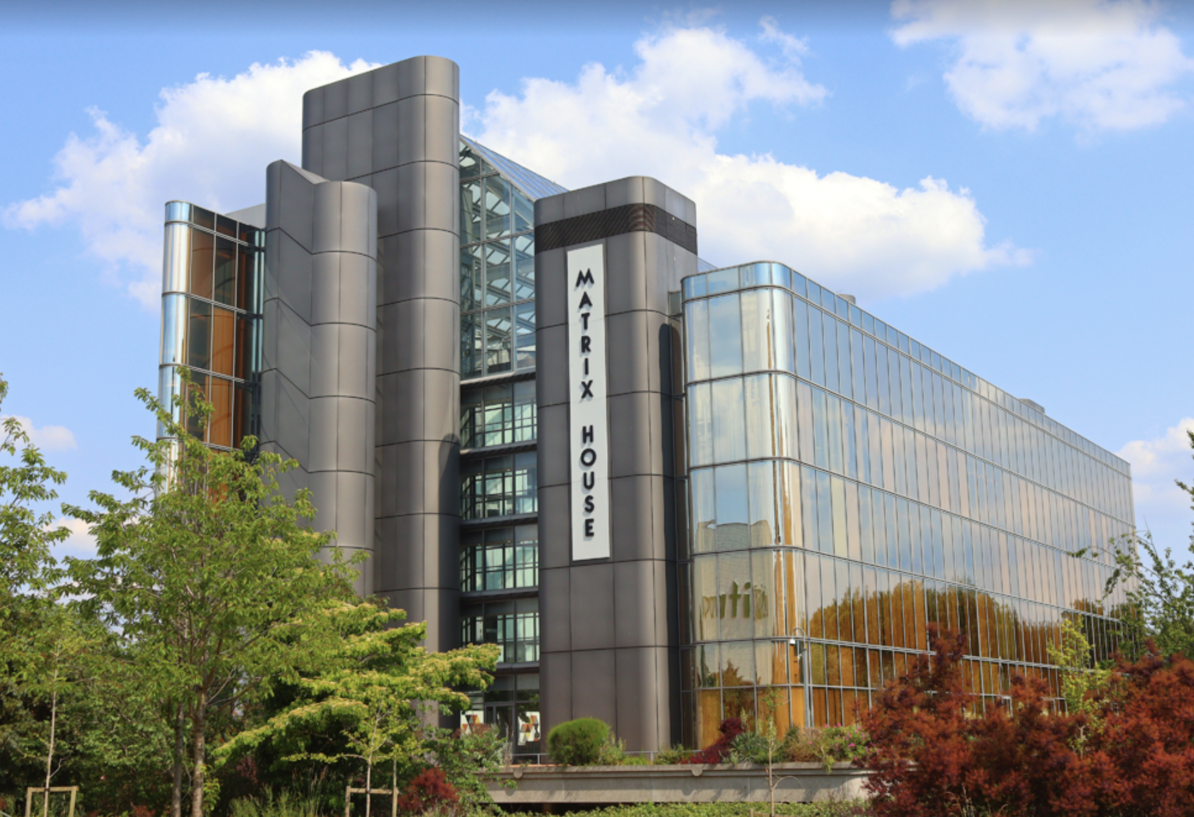 Illustration of a modern high-rise office building with a prominent Matrix House sign