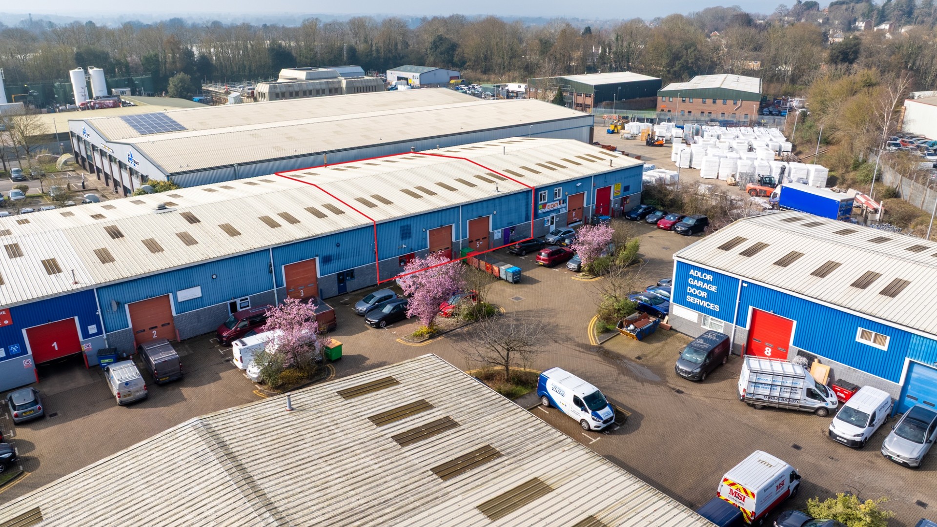 Aerial view of Britannia Business Park in Aylesford, showing commercial units, parking areas and several vehicles.