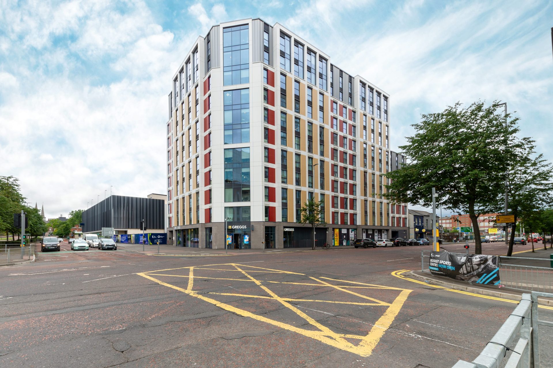 The Edge student accommodation building in Belfast, viewed from across a marked car park.