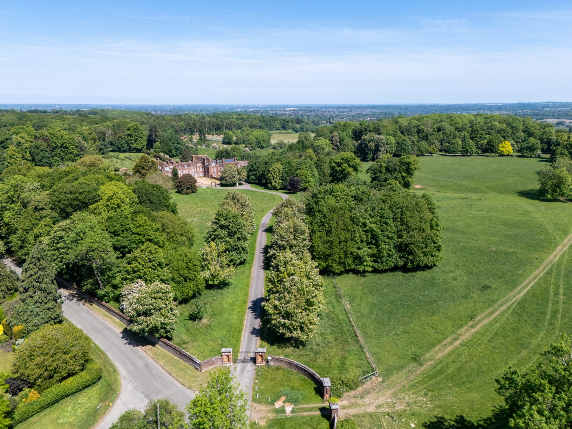 Aerial view of Temple Dinsley Park, with the former school buildings amid landscaped grounds and parkland.