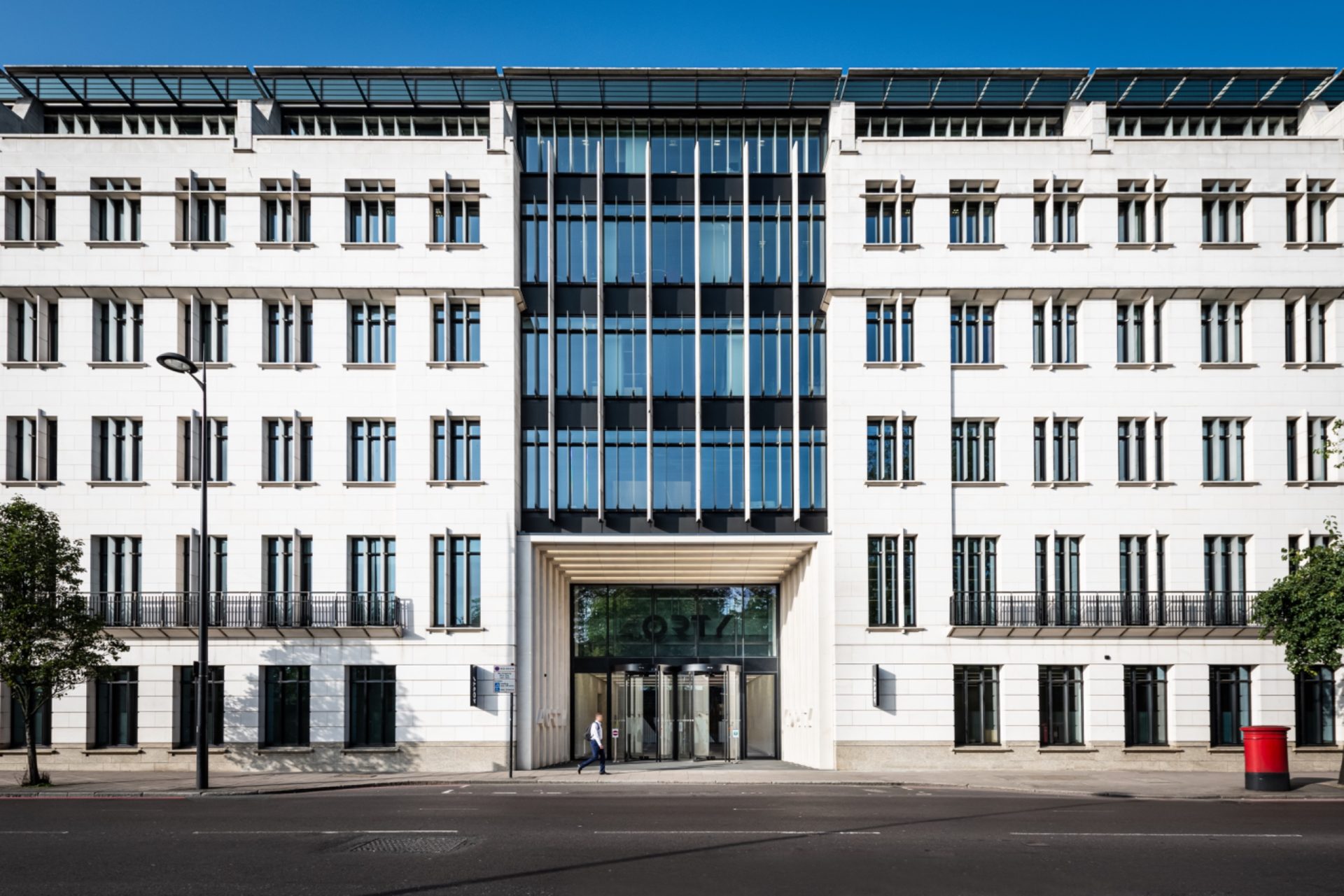 Exterior of 40 Grosvenor Place, a white multi-storey office building with a glass-fronted central entrance.
