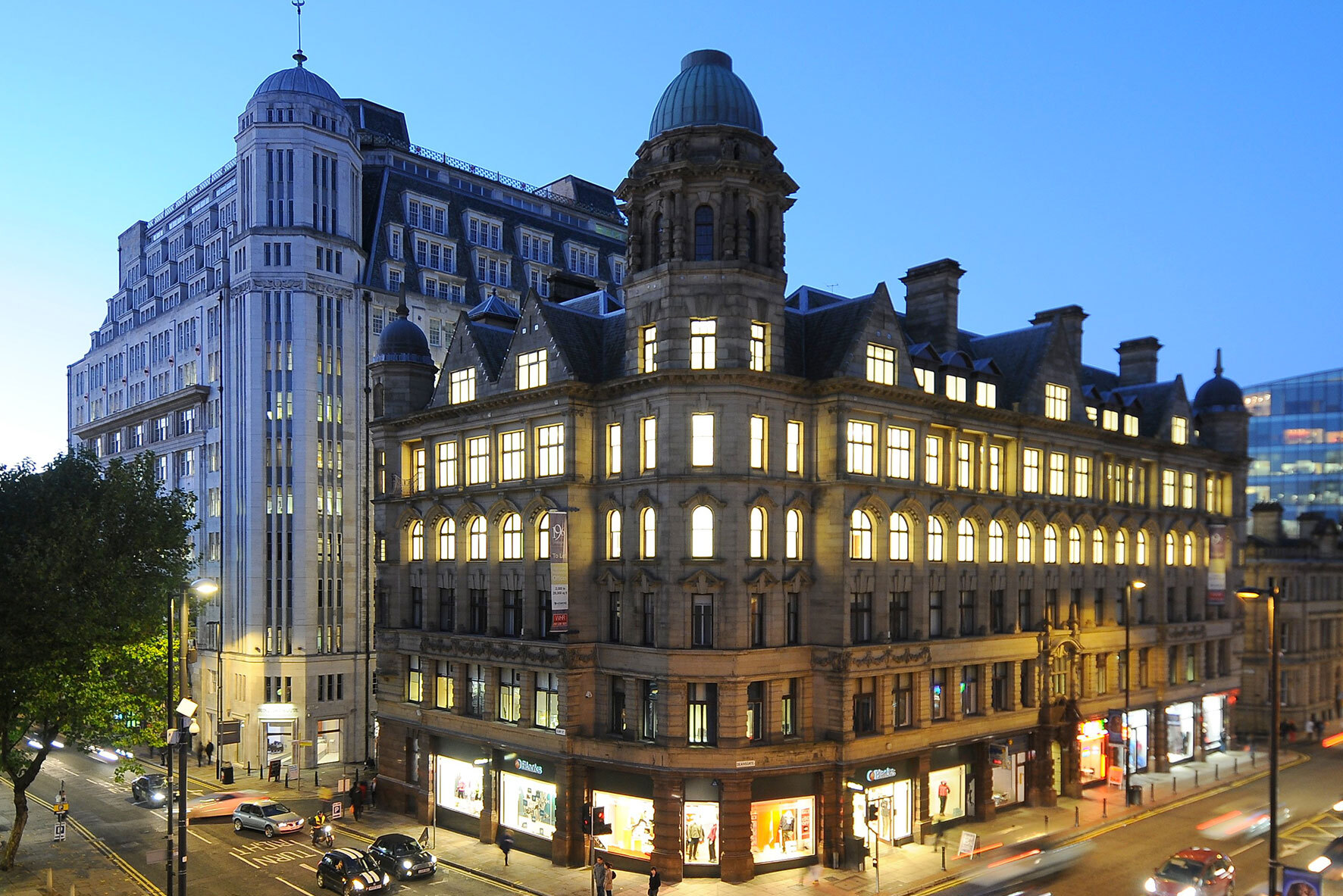 Architectural rendering of a grand historic commercial building on a busy city street at dusk