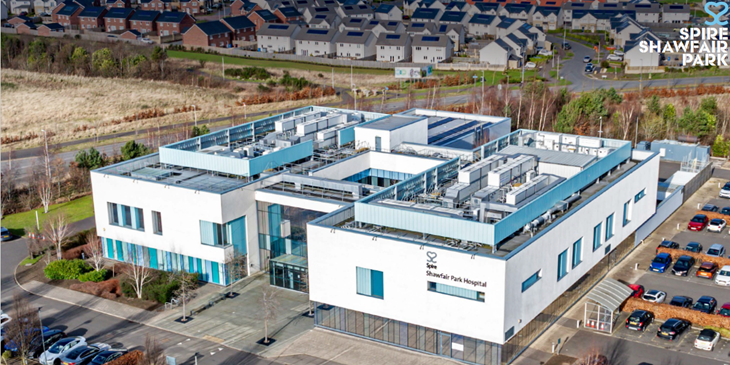 Aerial view of Shawfair Park Hospital, a modern low-rise building with parking and landscaped grounds.
