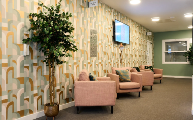 A room with chairs along the left hand wall