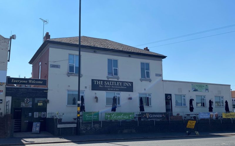 A white building with the words Saltley Inn on the front