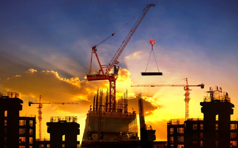 big crane and building construction against beautiful dusky sky use for construction industry and engineering