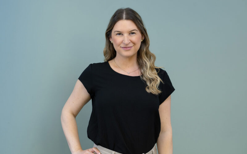 A woman with long hair wearing a black top