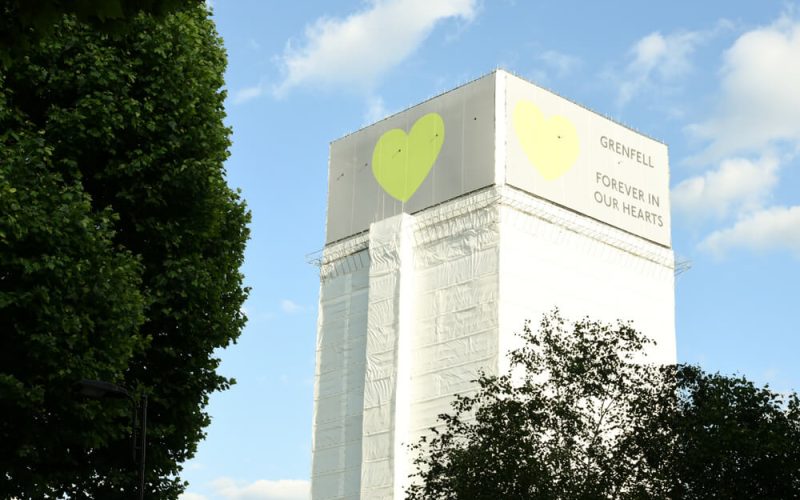The Grenfell Tower surrounded by a hoarding