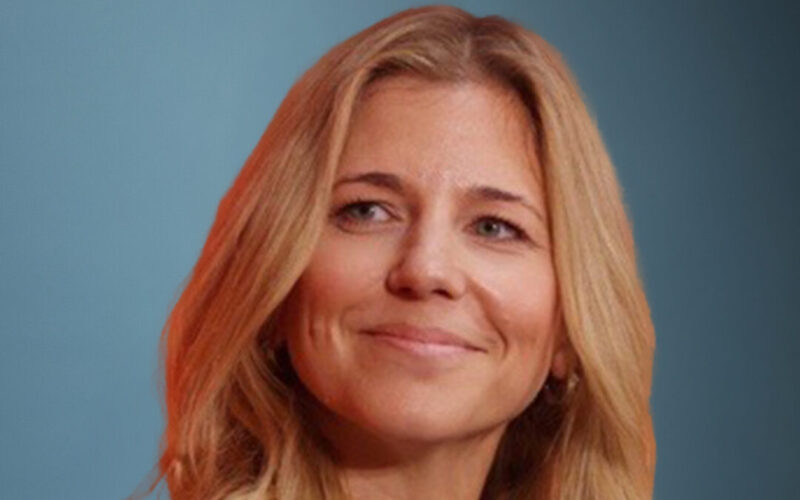 A smiling white woman with long hair