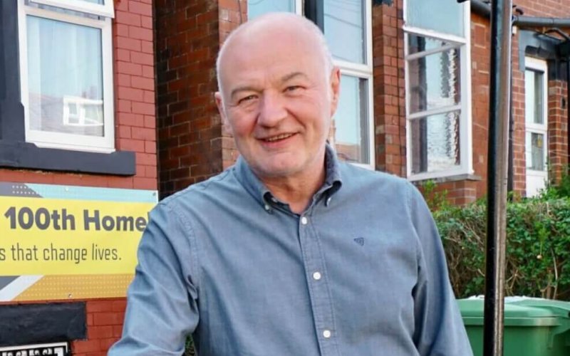 Latch CEO James Hartley outside the 100th home