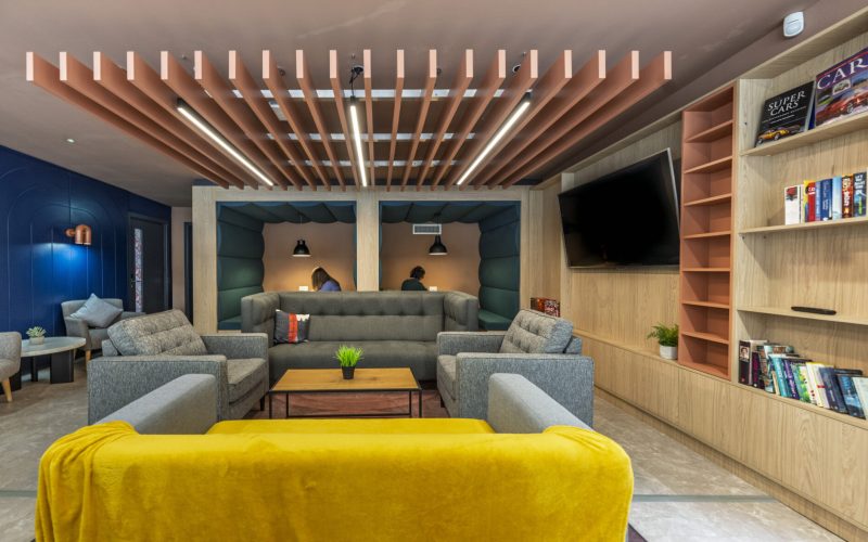 Interior of a PBSA building featuring soft furnishings and booths for people working