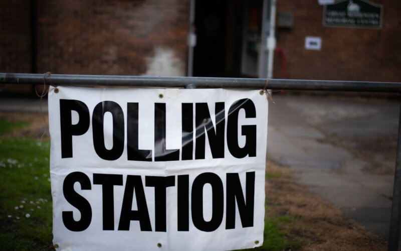 White,And,Black,Polling,Station,Sign,On,A,Metal,Tubed