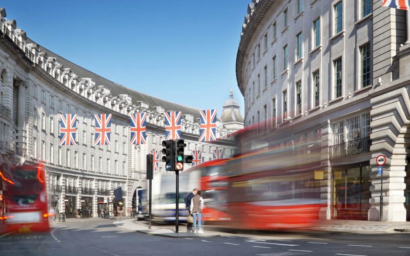 London,,Regent,Street,With,Jack,Union,Flags,And,Red,Buses