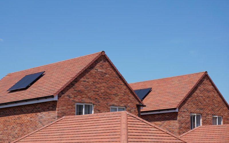 A series of roofs of red brick built houses