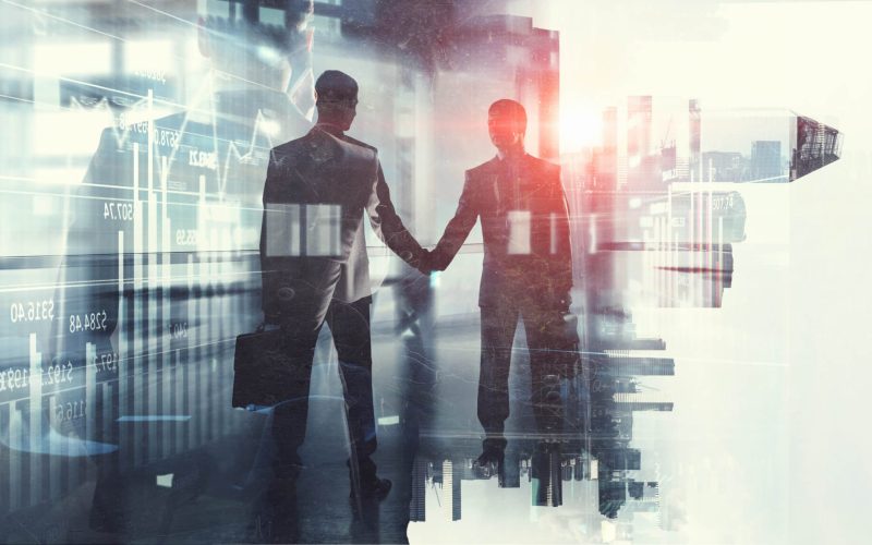 Two people shaking hands in a business deal