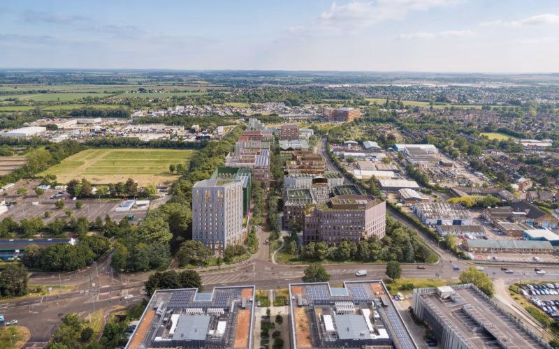 CGI aerial view of a series of buildings surrounded by green fields