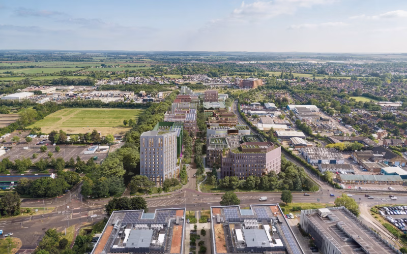 CGI aerial view of a series of buildings surrounded by green fields