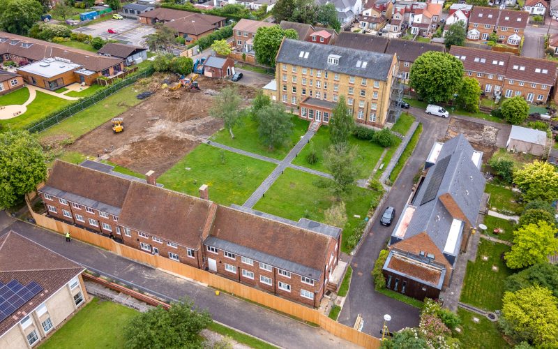 Aerial view of houses with a green square in the middle