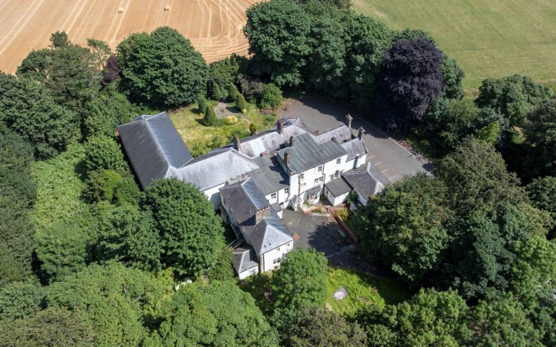 Aerial view of a series of buildings in the middle of a wooded area