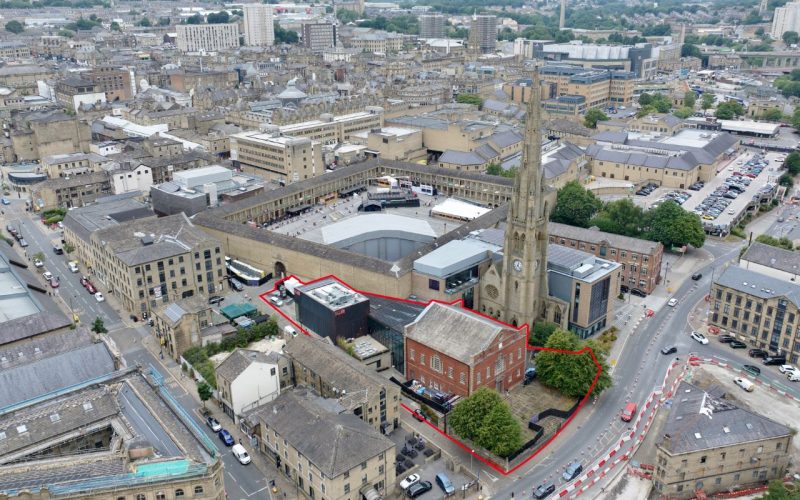 Aerial view of a town centre with a building outlined in red