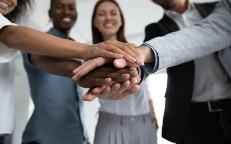 Close,Up,Happy,Diverse,Business,People,Putting,Hands,Together,,Showing