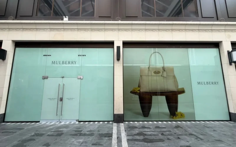 Exterior of a retail store with Mulberry signs in the window