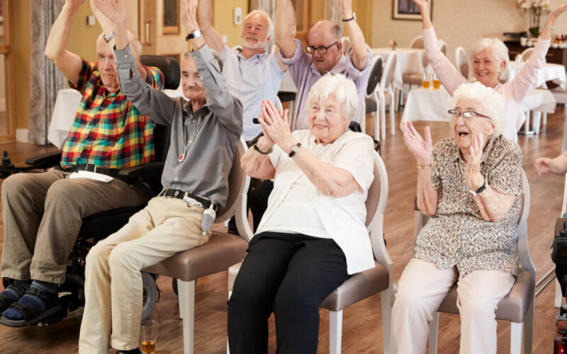 Carer,Leading,Group,Of,Seniors,In,Fitness,Class,In,Retirement