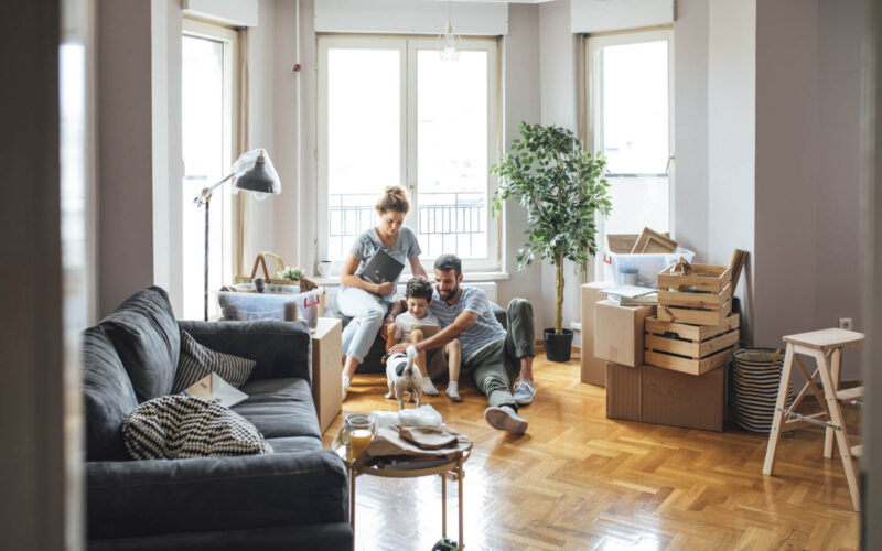 Husband,And,Wife,And,Their,Child,Moving,In,New,Home.