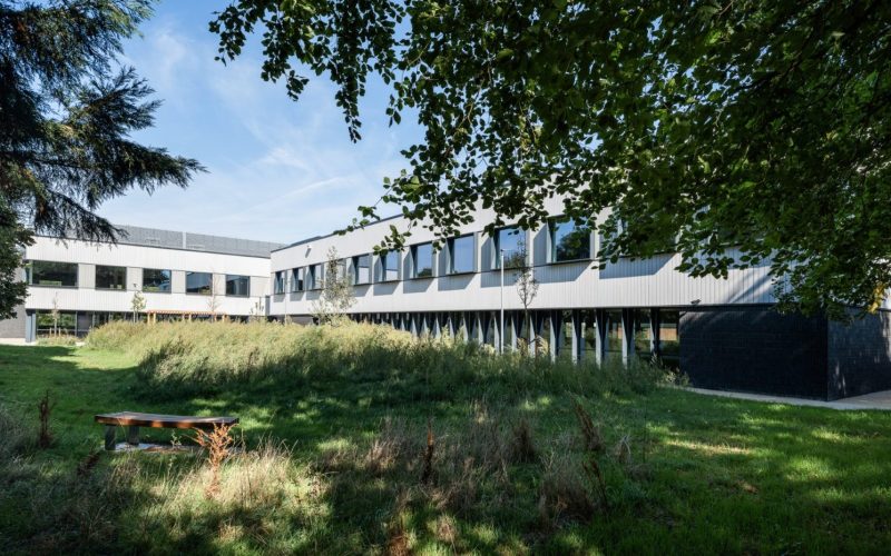 The Press science campus in Foxton, a modern low-rise building behind a lawn and trees.