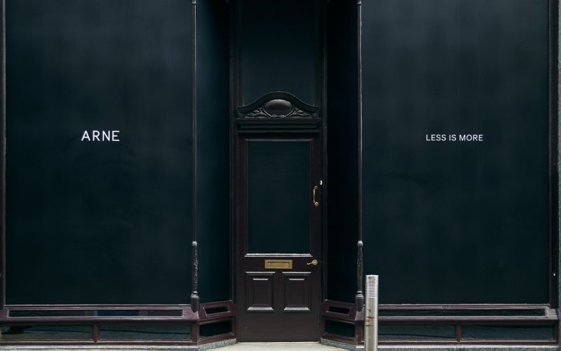 ARNE storefront in Victoria Quarter, Leeds, with a black facade and central entrance