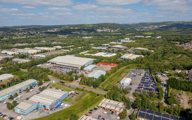 Aerial view of warehouses, industrial units and vehicle yards in a Welsh business park