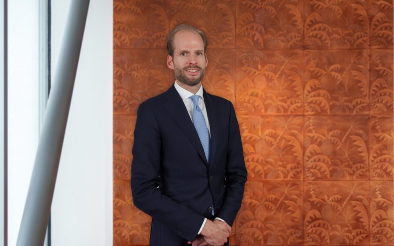 Niek van Genugten, fund manager at Edmond de Rothschild REIM, standing in a suit before a patterned wall