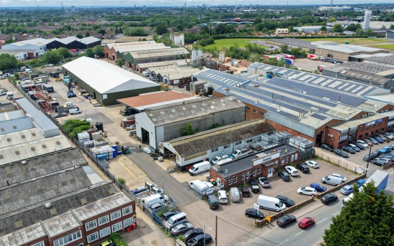 Aerial view of warehouses and industrial units at 40 Bayton Road, Coventry, with parked cars and loading areas.