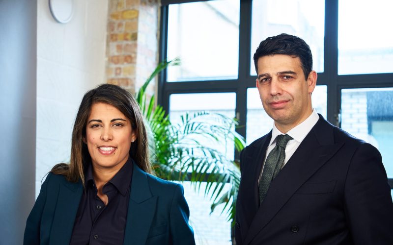 Sonia Gill and Paul Dodds of DG Capital Partners pose together in an office