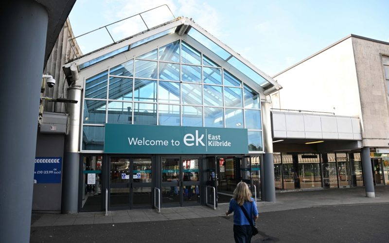 Entrance to East Kilbride shopping centre, with glass-fronted doors beneath a sign reading “Welcome to EK East Kilbride”.